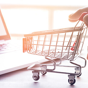 Online shopping and taxation concept with hand and cart