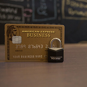 An American Express card with a lock in front of it