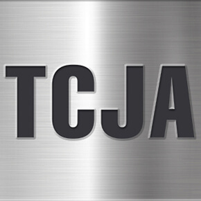 Letters TCJA in black with silver background