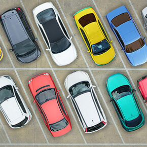 Different color vehicles in a parking lot