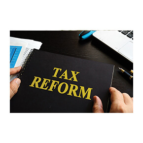 Tax Reform written on a book with someone holding it