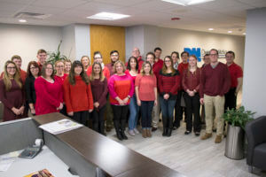 A group of Dannible & McKee employees dressed in red in support of the American Heart Association