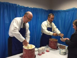 Partners of Dannible & McKee, Chris Didio and Brian Johnson scooping and serving ice cream