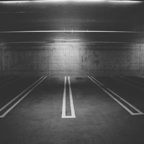 A dark parking garage with open spaces