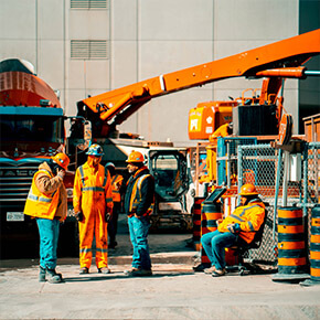 Construction Workers on Site in front of equipment