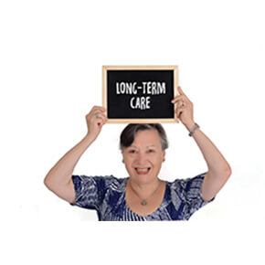 Older woman holding LongTerm Care Sign