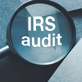 magnifying glass with IRS Audit written on it