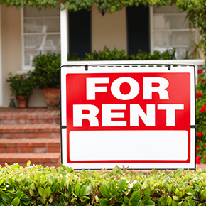 A for rent sign in front of house