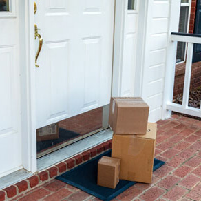 Three boxes on brick porch stacked in front of front door