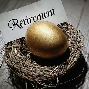 Golden egg in nest with slip of paper behind with the word retirement on it in calligraphy