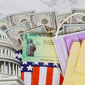 Capitol building, $100 bills, face mask, surgical glove, and part of the American flag COVID relief