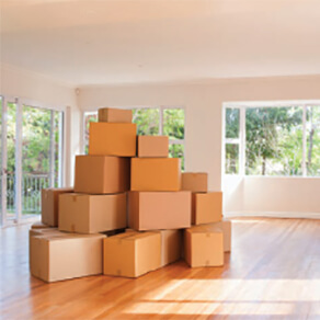Moving boxes stacked in empty house