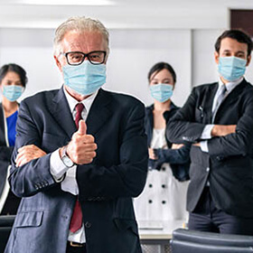 Confident business people with face mask protect from Coronavirus or COVID-19. Concept of help, support and collaboration together to overcome epidemic of Coronavirus or COVID-19 to reopen business