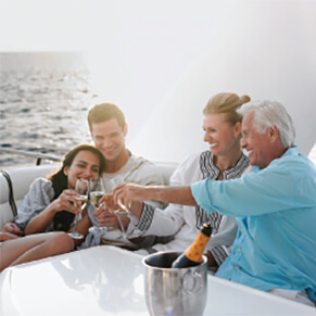 Two couples sitting on a boat toasting