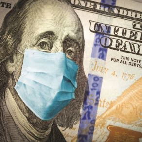 Close up of $100 bill with Benjamin Franklin wearing a medical face mask