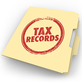 Tax Records words stamped onto a manila folder to keep your documents in a file to be pulled from your historical archive in case of an audit