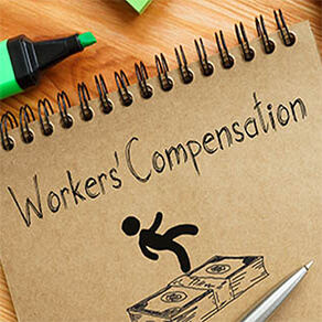 Spiral notebook with words "workers' compensation" and image of person slipping on stack of money