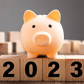 Budget Plan 2023. Piggy Bank on top of wooden block