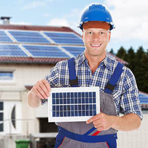 Smiling Repairman Holding Solar Panel In Front Of The House