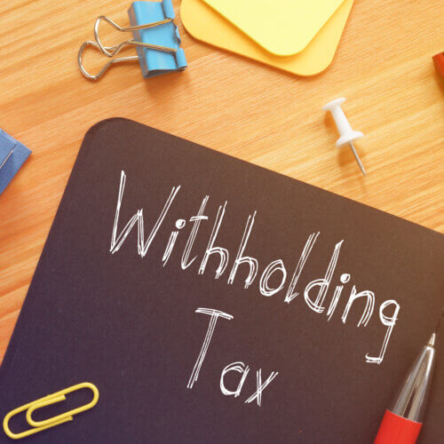 Withholding Tax is shown on the conceptual business photo