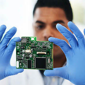 Shot of a young man repairing computer hardware in a laboratory