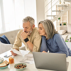 An older couple looking at financial records