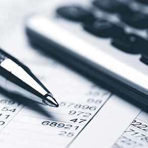 Financial statements with a pen and calculator