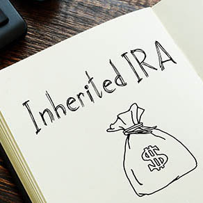 "Inherited IRA" is shown with drawing of a money bag on a open notebook
