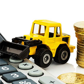 Toy bulldozer pushing coins and a calculator